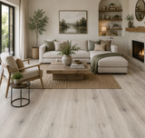 8052-2 Grey Owl 5MM Desertland SPC flooring installed in a bright modern living room featuring light grey oak tones and contemporary styling